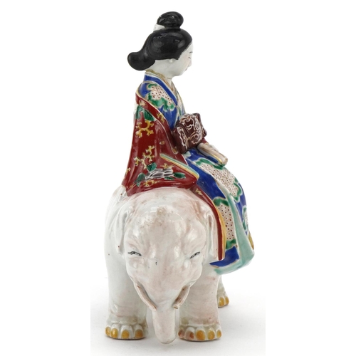 374 - A Japanese porcelain model of a Bijin riding a white elephant, Meiji period, with hand painted decor... 