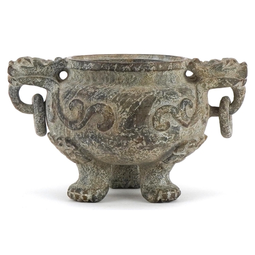 156 - A Chinese reconstituted hardstone tripod censer with dragon mask handles, decorated in relief, 9cm H... 