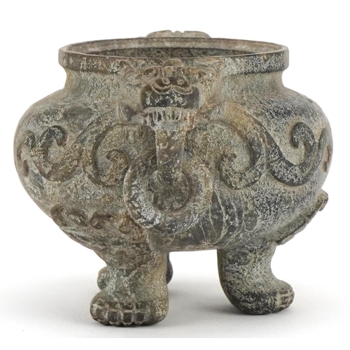 156 - A Chinese reconstituted hardstone tripod censer with dragon mask handles, decorated in relief, 9cm H... 