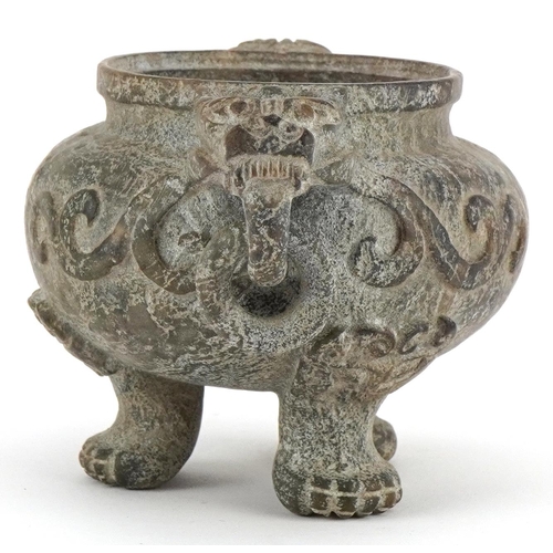 156 - A Chinese reconstituted hardstone tripod censer with dragon mask handles, decorated in relief, 9cm H... 