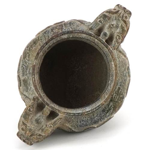 156 - A Chinese reconstituted hardstone tripod censer with dragon mask handles, decorated in relief, 9cm H... 