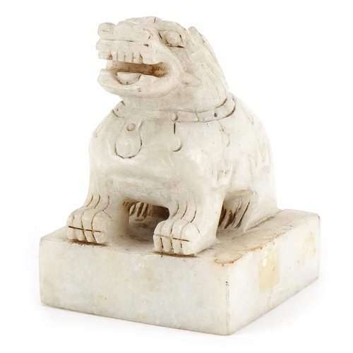 254 - A Chinese carved alabaster desk seal, 20th century, in the form of a Foo dog, four character mark to... 