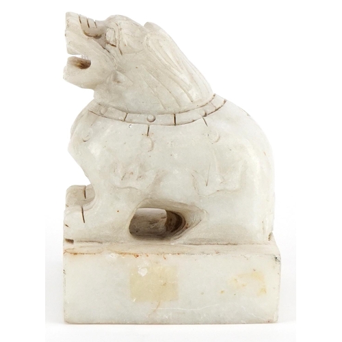 254 - A Chinese carved alabaster desk seal, 20th century, in the form of a Foo dog, four character mark to... 