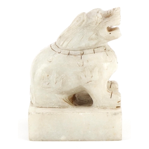 254 - A Chinese carved alabaster desk seal, 20th century, in the form of a Foo dog, four character mark to... 