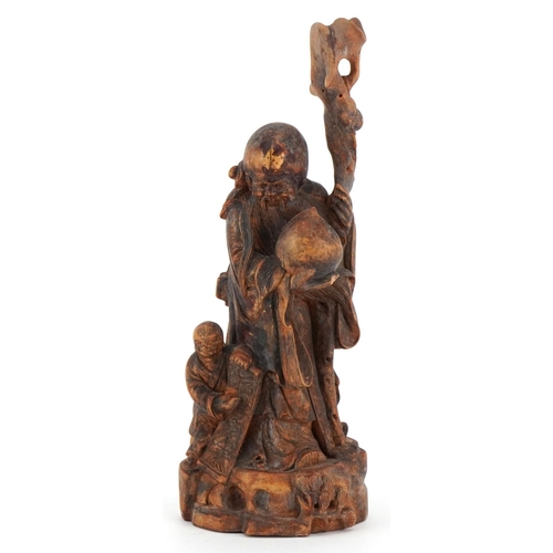 252 - A Chinese carved softwood figure of an immortal and child, 20th century, 25cm high.