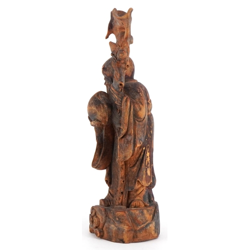 252 - A Chinese carved softwood figure of an immortal and child, 20th century, 25cm high.