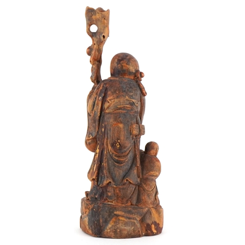 252 - A Chinese carved softwood figure of an immortal and child, 20th century, 25cm high.