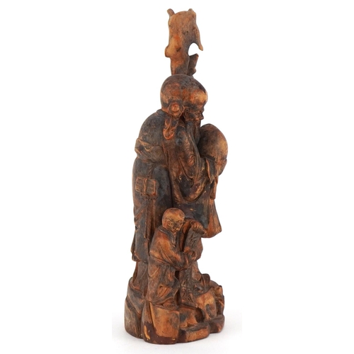 252 - A Chinese carved softwood figure of an immortal and child, 20th century, 25cm high.