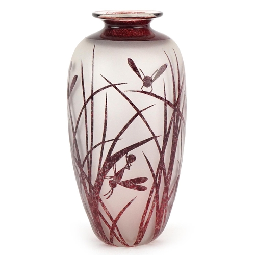 2560 - An Art Deco style red cameo acid etched glass vase decorated with insects amongst grass, with overtu... 