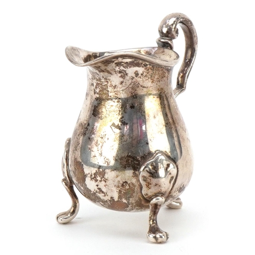 586 - William Brown & William Nathaniel Somersall, a Victorian silver cream jug raised on three paw feet, ... 