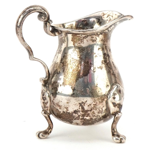 586 - William Brown & William Nathaniel Somersall, a Victorian silver cream jug raised on three paw feet, ... 