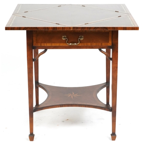 2134 - A late 20th century walnut envelope card table with cross banded decoration, the rotating top raised... 