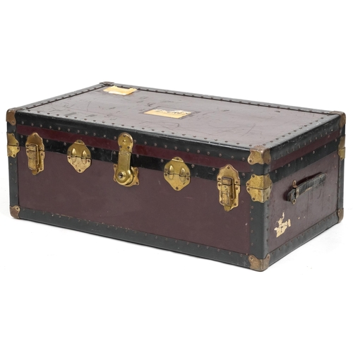 2032 - An early 20th century brass bound travelling trunk, the hinged lid revealing a removeable tray, 37cm... 