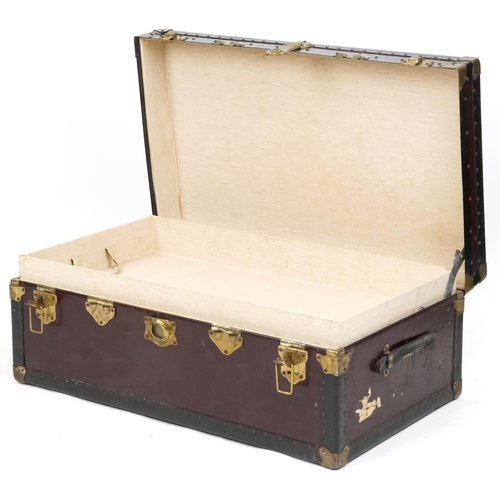 2032 - An early 20th century brass bound travelling trunk, the hinged lid revealing a removeable tray, 37cm... 