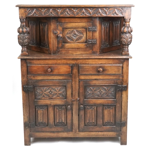 2154 - A 20th century Jacobean Revival oak court cupboard with carved decoration, fitted with two drawers a... 