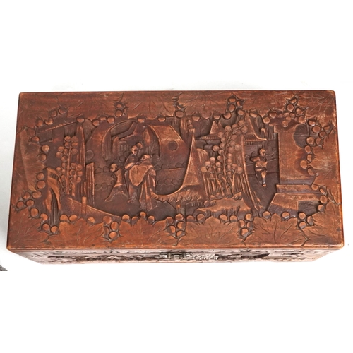 2135 - A Chinese camphor trunk with carved decoration, 20th century, 58cm H x 101cm W x 53cm D, together wi... 