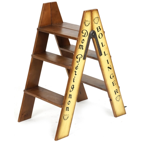 2133 - A pair of late 20th century three rung folding step ladders decorated with Moët & Chandon sides, 85c... 