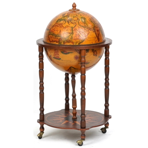 2155 - A late 20th century territorial drinks globe raised on turned supports united by an under tier, 88cm... 