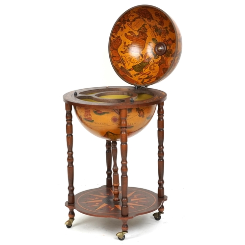 2155 - A late 20th century territorial drinks globe raised on turned supports united by an under tier, 88cm... 