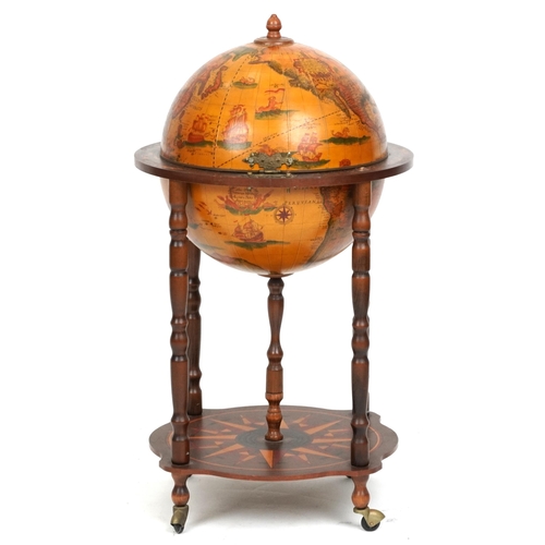 2155 - A late 20th century territorial drinks globe raised on turned supports united by an under tier, 88cm... 