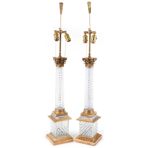 482 - A pair of acanthus column design gilt brass and glass table lamps, 108cm high.