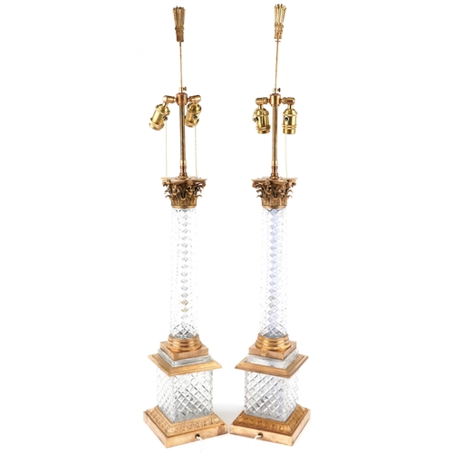 482 - A pair of acanthus column design gilt brass and glass table lamps, 108cm high.