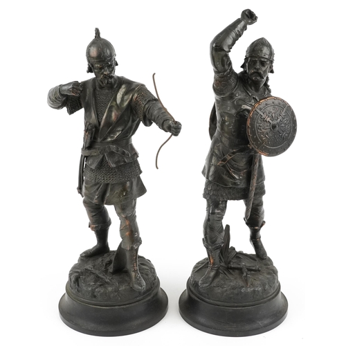 264 - After Emile Bruchon, a pair of bronzed spelter Viking figures, the largest 50cm high.