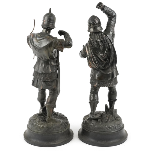 264 - After Emile Bruchon, a pair of bronzed spelter Viking figures, the largest 50cm high.