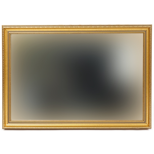 2104 - A modern gilt framed rectangular wall mirror, 60cm x 85cm.