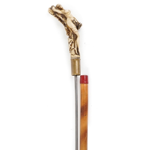 404 - A 19th century bamboo swordstick with moulded bone design handle in the form of a nude female with b... 