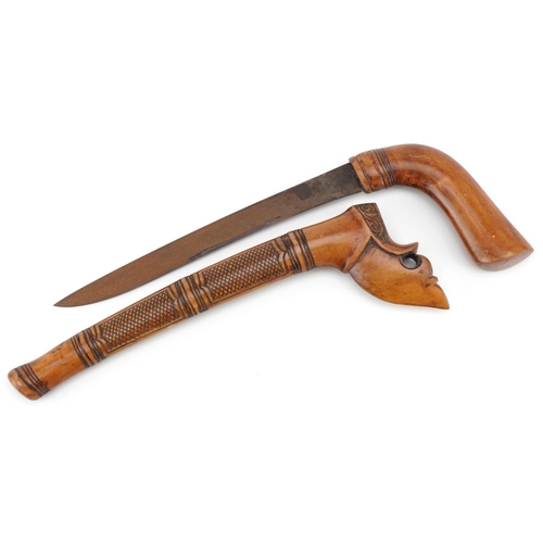 130 - An Indonesian wooden handled kris knife with scabbard, 27cm in length.