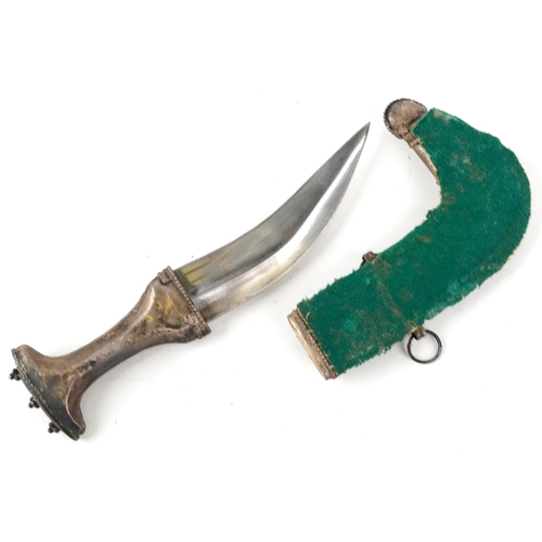 125 - A Middle Eastern white metal jambiya curved edged blade dagger, early 20th century, with engraved de... 