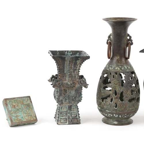 466 - A small group of Chinese bronze items, 20th century, including a tripod censer, a desk seal, a squar... 