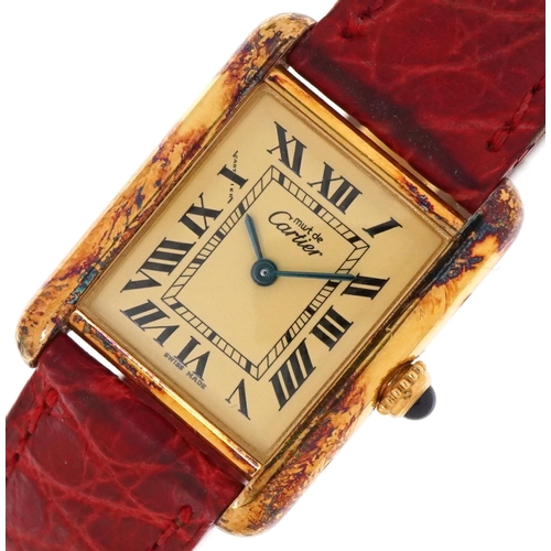 Cartier, a ladies Must de Cartier silver gilt quartz wristwatch with blue cabochon crown, the case numbered 168159PL, 22mm wide, housed in a Cartier box.