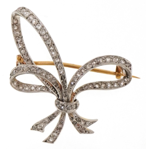 3058 - An antique unmarked two tone gold diamond bow brooch, 3.4cm high, 8.0g.