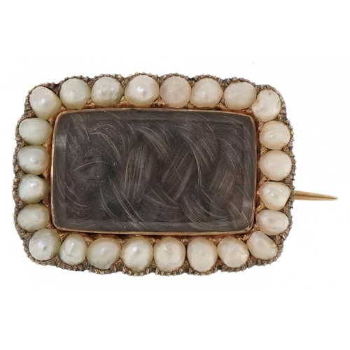 3054 - A Victorian unmarked gold seed pearl and hairwork mourning brooch with 1835 inscription to the rever... 