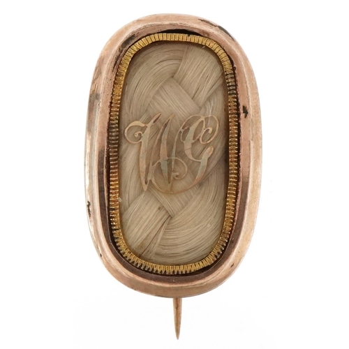 3075 - An antique unmarked gold hairwork mourning brooch, 2.6cm wide, 4.0g.