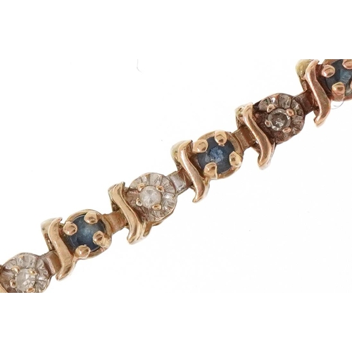 3042 - A 9ct gold diamond and sapphire line bracelet, 20cm in length, 6.2g.