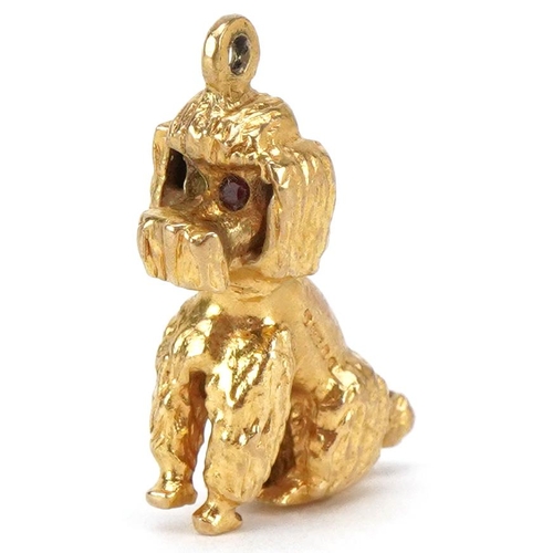 3139 - A 9ct gold charm in the form of a seated Poodle, 2.2cm high, 5.5g.