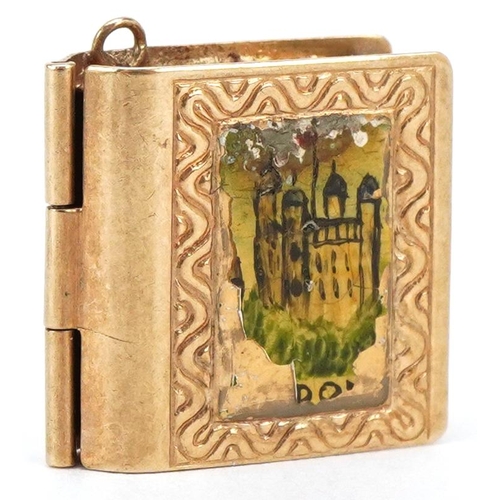 3402 - A 9ct gold and enamel opening charm in the form of a book, 1.5cm high, 1.9g.