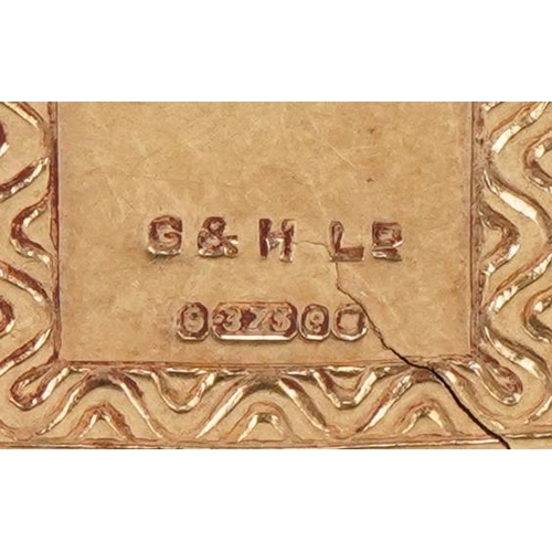 3402 - A 9ct gold and enamel opening charm in the form of a book, 1.5cm high, 1.9g.