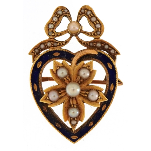 3043 - An antique unmarked gold and blue enamel love heart and bow brooch set with seed pearls, 3.1cm high,... 