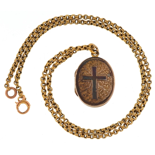 3411 - A yellow metal oval locket engraved with a cross on a 15ct gold necklace, 2.4cm high and 40cm in len... 