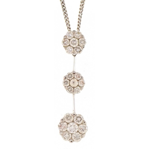 3060 - An 18ct white gold diamond triple flower head pendant on an 18ct white gold necklace, 2.5cm high and... 