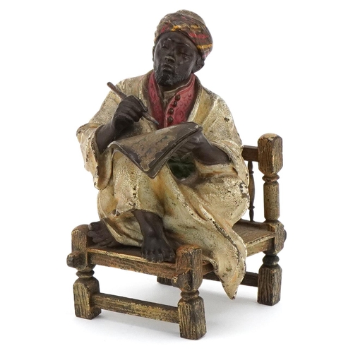 An early 20th century Austrian cold painted bronze of a seated Arabic gentleman by Franz Bergmann, bearing marks to base, Geschützt 2746, 11cm high.