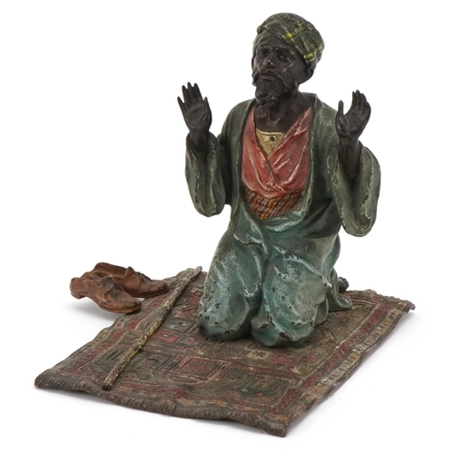 An early 20th century Austrian cold painted bronze of an Arabic man praying by Franz Bergmann, bearing marks to base, Geschützt and signed B,  14cm H x 14cm W x 10.5cm D.