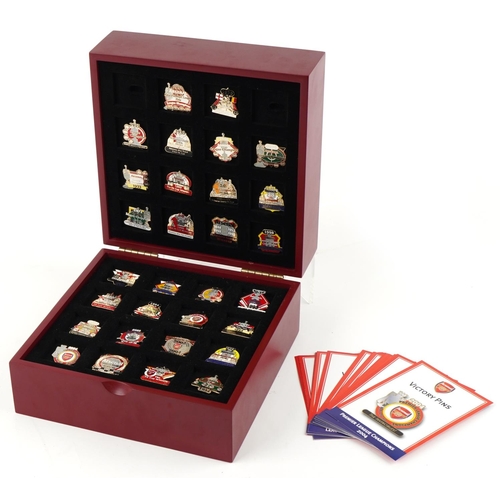 1415 - A collection of thirty Arsenal enamel Victory pin badges within a red wooden case, W-25cm.