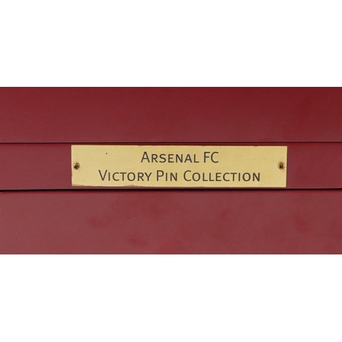 1415 - A collection of thirty Arsenal enamel Victory pin badges within a red wooden case, W-25cm.