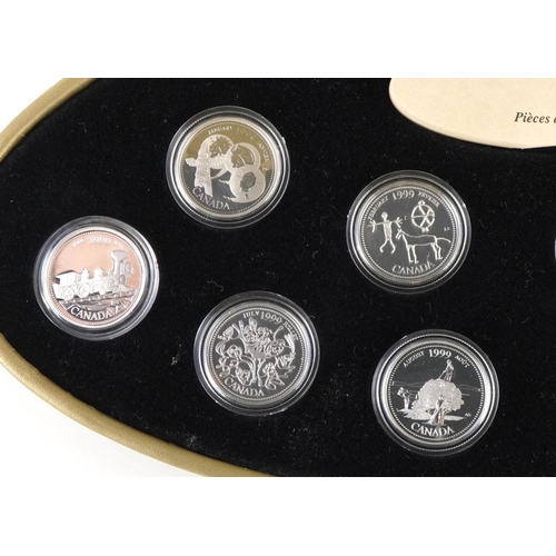 1315 - A 1999 Canada Millennium twelve coin set of silver twenty five cents, housed in an oval gold coloure... 