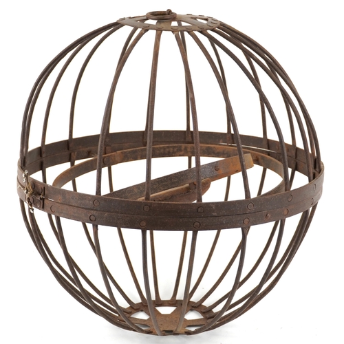 555 - An antique wrought iron hanging candle gimbal cage, approximately 46cm in diameter